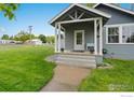Inviting covered porch with decorative accents, enhancing the home's entrance at 409 Main St, Mead, CO 80542