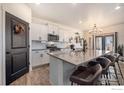 Stylish kitchen with stainless steel appliances, a large center island, and bar stool seating at 4403 Garnet Way, Longmont, CO 80504