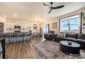 Open-concept living room featuring a modern kitchen, dining area, and comfortable seating at 4403 Garnet Way, Longmont, CO 80504