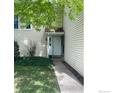 Charming home exterior featuring a well-kept lawn and classic white front door at 482 S Kalispell Way # E, Aurora, CO 80017