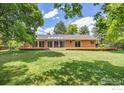 Expansive backyard with a large deck, perfect for outdoor entertaining and relaxation at 5314 S Youngfield Ct, Littleton, CO 80127