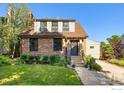 Charming two-story brick home with a well-manicured lawn and inviting walkway at 755 Lincoln Pl, Boulder, CO 80302