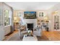 Cozy living room featuring comfortable seating, decorative fireplace, and ample natural light at 755 Lincoln Pl, Boulder, CO 80302