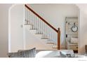 Bright, white staircase with a wooden handrail complements the neutral decor at 755 Lincoln Pl, Boulder, CO 80302