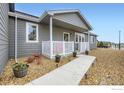 Single story home showcasing the entrance, landscaping and curb appeal at 7840 Cattail Grn, Frederick, CO 80530