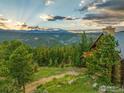 Wood home nestled in a forest with mountain views and wooden balcony at 1050 Pine St, Boulder, CO 80302