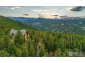 Beautiful wood cabin-style home nestled in the forest, showcasing stunning mountain views at 1050 Pine St, Boulder, CO 80302