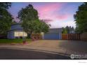 Charming home with a lovely front yard, mature trees, and a two-car garage at 1240 Snowbank Ct, Longmont, CO 80504