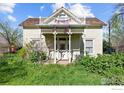 This classic home features a covered porch with decorative railings and a second-story balcony adorned with American flags at 1341 N 95Th St, Lafayette, CO 80026