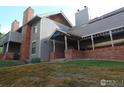 Exterior view of a multi-story home with brick accents and green grass at 1405 Broadway St # 302, Boulder, CO 80302