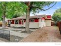 Beautiful home with mature trees, a well-maintained lawn, and ample parking at 1514 Collyer St, Longmont, CO 80501