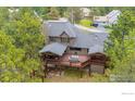 An aerial view of a multi-level wood deck and backyard, perfect for outdoor entertaining at 2023 Mammoth Ct, Evergreen, CO 80439