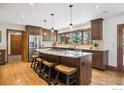 Gourmet kitchen featuring a large island, granite countertops, and stainless steel appliances at 2023 Mammoth Ct, Evergreen, CO 80439