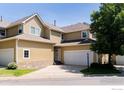 Exterior of the home featuring a two-car garage and well-maintained front yard at 211 Rockview Dr, Superior, CO 80027