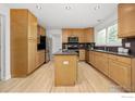 Well-lit kitchen with a functional island, stainless steel appliances, and ample cabinet space, ideal for cooking at 2205 Keota Ln, Superior, CO 80027