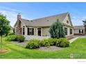 Beautifully landscaped front yard showcasing stone and shrubs at 2421 Santa Fe Dr # B, Longmont, CO 80504
