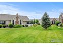 Residential lawn view with mulched trees enhancing the green space at 2421 Santa Fe Dr # B, Longmont, CO 80504