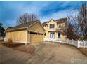 Inviting two-story home with a spacious driveway, two-car garage, and a charming white picket fence at 2946 Shoshone Trl, Lafayette, CO 80026