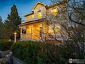 Beautiful two-story home featuring a covered porch, lush greenery, and well-maintained landscaping at 2946 Shoshone Trl, Lafayette, CO 80026