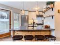 Stylish kitchen with stainless steel appliances, breakfast bar, and ample counter space at 3025 Broadway St # 18, Boulder, CO 80304