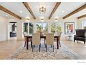 Dining room featuring wood beams, large windows, and hardwood floors at 31 Wild Tiger Ln, Boulder, CO 80302
