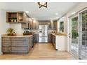 Modern kitchen featuring stainless steel appliances, custom cabinets, and granite countertops at 31 Wild Tiger Ln, Boulder, CO 80302