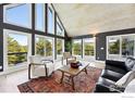 Bright living room featuring high ceilings, large windows, and scenic views at 31 Wild Tiger Ln, Boulder, CO 80302