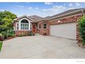 Inviting single-story brick home with a two-car garage and well-manicured landscaping at 3413 Boxelder Dr, Longmont, CO 80503