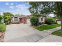 Beautiful single-story brick home with a large driveway and mature landscaping at 3413 Boxelder Dr, Longmont, CO 80503
