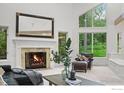 Inviting living room features a fireplace, large windows, wood beams, and cozy seating arrangements at 3421 4Th St, Boulder, CO 80304