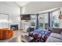 Bright living room with hardwood floors, a fireplace, and sliding doors to the outside at 5415 W 16Th Ave, Lakewood, CO 80214