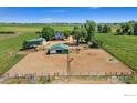 Sprawling property featuring multiple buildings, including a charming farmhouse and large horse paddock at 5416 County Road 36, Platteville, CO 80651