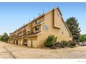 Multi-level condominium complex featuring garages, well-maintained landscaping, and abundant parking at 5918 Gunbarrel Ave # B, Boulder, CO 80301