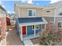 Two-story home featuring a cozy front porch and neutral, complementary siding colors at 67 Quail Rd, Longmont, CO 80501