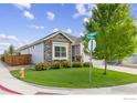 Well-kept lawn and landscaping with a charming exterior featuring stone accents at 688 Ten Gallon Dr, Berthoud, CO 80513