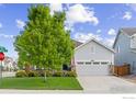 Charming single-Gathering home with a well-maintained lawn and a two-car garage on a sunny day at 688 Ten Gallon Dr, Berthoud, CO 80513