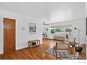 Bright living room featuring hardwood floors, natural light, and neutral paint at 733 E 2Nd Ave # 307, Denver, CO 80203