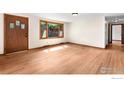 Bright living room featuring hardwood floors and a large window at 1247 Linden St, Longmont, CO 80501