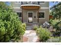 Inviting entrance with a stone pathway, decorative plants, and a stylish front door at 1260 Claremont Dr, Boulder, CO 80305