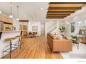 Spacious open-concept living area with hardwood floors, a modern staircase, and stylish furnishings at 1260 Claremont Dr, Boulder, CO 80305
