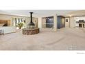 Bright, expansive living area with a striking stone fireplace, large bay windows, and open layout at 1323 Horizon Ln, Longmont, CO 80501