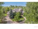 Beautiful exterior elevation of a home featuring well-maintained landscaping and a circular driveway at 145 Brittany Ln, Lafayette, CO 80026