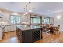 Well-appointed kitchen with a large island, stainless steel appliances, and an adjacent dining area at 145 Brittany Ln, Lafayette, CO 80026