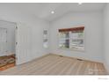Bright, carpeted bedroom featuring a large window and neutral tones at 1504 Taylor Mountain Dr, Longmont, CO 80503