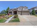 Beautiful two story home featuring stone accents, a lush front yard and a two car garage at 1504 Taylor Mountain Dr, Longmont, CO 80503