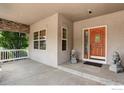 Inviting front porch with decorative stone lions and an entry door with sidelights at 1504 Taylor Mountain Dr, Longmont, CO 80503