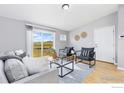 Bright living room with a sliding glass door, modern furniture, and neutral decor for a cozy space at 18674 County Road 3, Berthoud, CO 80513