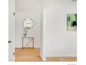 Bright entryway featuring hardwood floors, a decorative mirror, and a modern console table at 2025 Grape Ave, Boulder, CO 80304