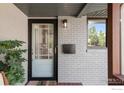 Close-up of the front door with modern hardware, a convenient mail slot, and a stylish light fixture at 2025 Grape Ave, Boulder, CO 80304