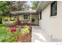 Inviting front porch with seating area surrounded by colorful flowers and manicured landscaping at 2025 Grape Ave, Boulder, CO 80304